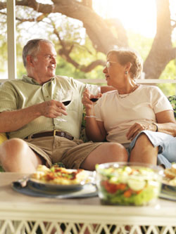 senior couple eating on patio in summer