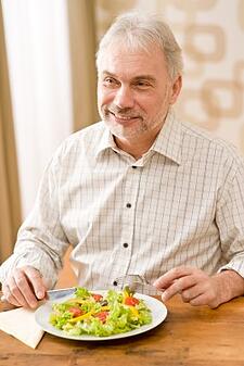 senior man eating a salad
