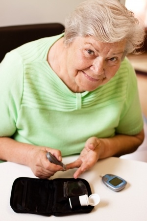 Senior woman checking her blood sugar