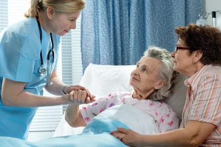 Senior and caregiver in hospital