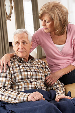 Mature woman trying to comfort an older man.