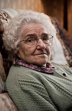 Elderly woman sitting in an easy chair