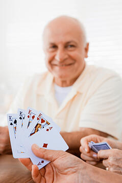 Group of seniors playing cards in a retirement community