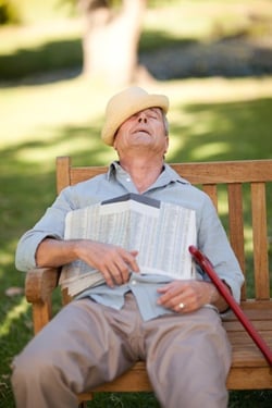 senior man asleep on bench