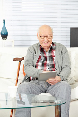 senior using tablet computer
