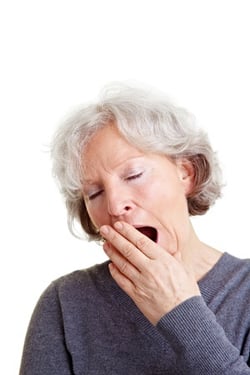 yawning senior woman