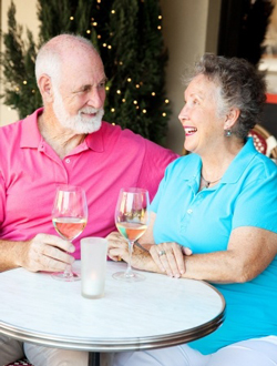 senior couple enjoying glass of wine at outdoor cafe
