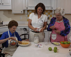 Judi Dean baking with residents of Deupree's senior care Cottages