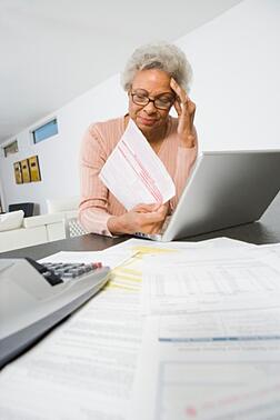 African American senior woman figuring out her personal finances